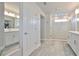 Luxurious primary bathroom with dual vanities, walk-in shower, and ceramic tile flooring at 5511 Del Coronado Dr, Apollo Beach, FL 33572