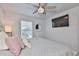 Bright bedroom featuring a decorative ceiling fan, comfy queen bed, and wall-mounted television at 5511 Del Coronado Dr, Apollo Beach, FL 33572