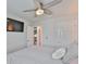 Well-lit bedroom featuring a ceiling fan and direct access to a cozy living space at 5511 Del Coronado Dr, Apollo Beach, FL 33572
