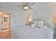 Comfortable bedroom with ensuite bathroom, ceiling fan, and plush bedding, designed for relaxation at 5511 Del Coronado Dr, Apollo Beach, FL 33572