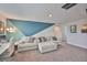 Open bonus room with large couch and a modern, geometric accent wall at 5511 Del Coronado Dr, Apollo Beach, FL 33572