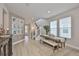 Dining area features a long wooden table with bench seating and staircase with natural light at 5511 Del Coronado Dr, Apollo Beach, FL 33572