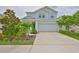 Charming two-story home features a well-manicured lawn and a two-car garage at 5511 Del Coronado Dr, Apollo Beach, FL 33572