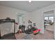 Home gym featuring a treadmill, stationary bike, and free weights for a complete workout experience at 5511 Del Coronado Dr, Apollo Beach, FL 33572
