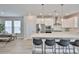 Bright kitchen boasts stainless steel appliances, a large quartz island with barstool seating, and pendant lighting at 5511 Del Coronado Dr, Apollo Beach, FL 33572