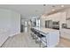 Bright open kitchen boasts stainless steel appliances, a large quartz island with barstool seating, and plenty of light at 5511 Del Coronado Dr, Apollo Beach, FL 33572