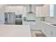 Kitchen features stainless steel appliances, sleek white cabinetry, subway tile backsplash, and ample counter space at 5511 Del Coronado Dr, Apollo Beach, FL 33572