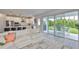 Open-concept living area with sliding glass doors to patio features a comfortable white sectional and bright decor at 5511 Del Coronado Dr, Apollo Beach, FL 33572