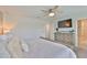 Bedroom with large TV, walk-in bathroom, and bright, neutral paint tones at 5511 Del Coronado Dr, Apollo Beach, FL 33572