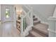 Elegant staircase with carpeted steps and white railing, bright natural light at 5511 Del Coronado Dr, Apollo Beach, FL 33572