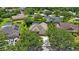Aerial view featuring a well-maintained home with mature trees and a neatly manicured lawn at 5519 Reflections Blvd, Lutz, FL 33558