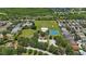 Overhead view showcasing the community's amenities including tennis court and green fields at 5519 Reflections Blvd, Lutz, FL 33558