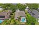 An aerial view showcases the house and pool, highlighting its integration with surrounding landscaping at 5519 Reflections Blvd, Lutz, FL 33558