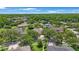 Wide aerial shot of a home surrounded by green landscaping and mature trees on a sunny day at 5519 Reflections Blvd, Lutz, FL 33558