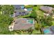Aerial view showcasing the beautiful home with a screened-in pool and lush landscaping at 5519 Reflections Blvd, Lutz, FL 33558