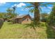 Private backyard features a small window, tropical greenery and landscaping, providing a serene view at 5519 Reflections Blvd, Lutz, FL 33558