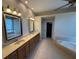Bright bathroom featuring double sinks, tub, and vanity with mirrors at 5519 Reflections Blvd, Lutz, FL 33558