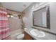 Bathroom featuring a shower-tub combo, single sink vanity, and a large framed mirror above the sink at 5519 Reflections Blvd, Lutz, FL 33558