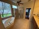 Bathroom features a soaking tub, stand up shower, and neutral tile floors at 5519 Reflections Blvd, Lutz, FL 33558