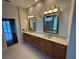 Bathroom showcasing double sinks, vanity with mirrors, and recessed lighting at 5519 Reflections Blvd, Lutz, FL 33558