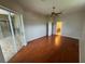Spacious bedroom featuring wood floors and neutral walls leading to the bathroom at 5519 Reflections Blvd, Lutz, FL 33558