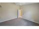 Bright bedroom with a door, ceiling fan, neutral carpet, and a doorway to another room at 5519 Reflections Blvd, Lutz, FL 33558