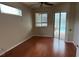 Bright bedroom featuring wood floors, neutral walls, ceiling fan, and natural lighting at 5519 Reflections Blvd, Lutz, FL 33558