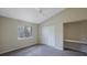 Bedroom features carpet, ceiling fan, a window, a double closet, and a built-in desk space at 5519 Reflections Blvd, Lutz, FL 33558