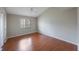 Cozy bedroom featuring wood flooring, a window bringing in natural light, and a ceiling fan at 5519 Reflections Blvd, Lutz, FL 33558