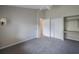 Carpeted bedroom with white trim, ceiling fan, double door closet, and built in desk area at 5519 Reflections Blvd, Lutz, FL 33558