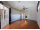 Large bedroom with wood floors, fan, and slider to screened porch; ensuite bathroom at 5519 Reflections Blvd, Lutz, FL 33558