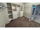 Walk-in closet featuring white shelving, drawer units and storage at 5519 Reflections Blvd, Lutz, FL 33558