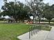 Scenic community park with playground, volleyball court, picnic shelter, and green space at 5519 Reflections Blvd, Lutz, FL 33558