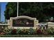 Villa Rosa community sign surrounded by colorful flowers and manicured greenery at 5519 Reflections Blvd, Lutz, FL 33558