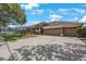 Traditional single-story home featuring a three-car garage and well-manicured lawn with shade trees at 5519 Reflections Blvd, Lutz, FL 33558