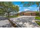 Traditional single-story home featuring a three-car garage and well-manicured lawn with shade trees at 5519 Reflections Blvd, Lutz, FL 33558