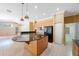 Open kitchen with a granite island, tile floors, and wooden cabinets at 5519 Reflections Blvd, Lutz, FL 33558