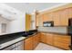 A kitchen with tile floors, wooden cabinets and granite countertops at 5519 Reflections Blvd, Lutz, FL 33558