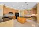 Kitchen with an island, wooden cabinets and black appliances at 5519 Reflections Blvd, Lutz, FL 33558