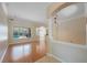 Spacious living room featuring hardwood floors, arched doorway with views of the screened-in pool at 5519 Reflections Blvd, Lutz, FL 33558