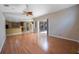 Inviting living room with wood floors, ceiling fan, and connecting to the kitchen area at 5519 Reflections Blvd, Lutz, FL 33558