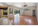 Open-concept living area with wood floors, sliding glass doors to the pool and backyard at 5519 Reflections Blvd, Lutz, FL 33558
