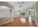 Open-concept living room with hardwood floors and a view of the outdoor pool at 5519 Reflections Blvd, Lutz, FL 33558