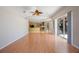 Light-filled living room features wood floors and views of the kitchen at 5519 Reflections Blvd, Lutz, FL 33558