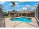 A backyard view features a screened-in pool, spa, and patio, perfect for outdoor living at 5519 Reflections Blvd, Lutz, FL 33558