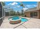 A screened-in pool and spa with brick pavers offers a private outdoor oasis at 5519 Reflections Blvd, Lutz, FL 33558
