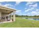 Spacious backyard with a covered patio, grill and scenic water view for relaxing outdoor living at 5620 Night Owl Ter, Palmetto, FL 34221
