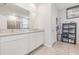 Bathroom features dual sinks with granite counters and storage shelves at 5620 Night Owl Ter, Palmetto, FL 34221