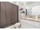 Well-lit bathroom featuring a granite countertop, dark fixtures, and decorative accents at 5620 Night Owl Ter, Palmetto, FL 34221