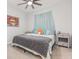 Inviting bedroom with a ceiling fan, beach-themed art, and stylish decor for a tranquil retreat at 5620 Night Owl Ter, Palmetto, FL 34221